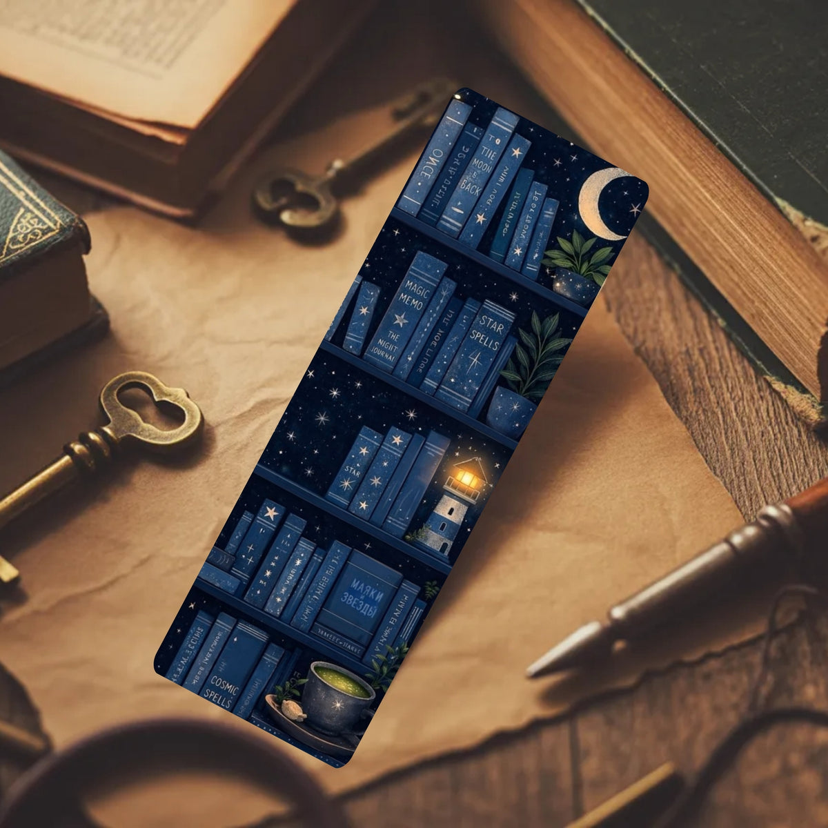 A rectangular bookmark or card featuring a dark blue bookshelf pattern with stars, a crescent moon, and a small lantern, placed on a warm brown desk with old books, keys, and a pen.