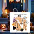 Spooky Halloween greeting card with the message “Wishing You A Spook-Tacular Halloween,” featuring a purple witch hat, flying black bats, full moon, cute ghost, spider, black cat, broomstick and bubbling green cauldron on an orange and purple Halloween background.