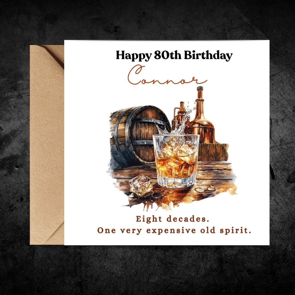 A personalized 80th birthday card with a kraft envelope, featuring a watercolor illustration of an old whiskey glass, barrel, and bottles. The card reads 'Happy 80th Birthday Connor' and 'Eight decades.