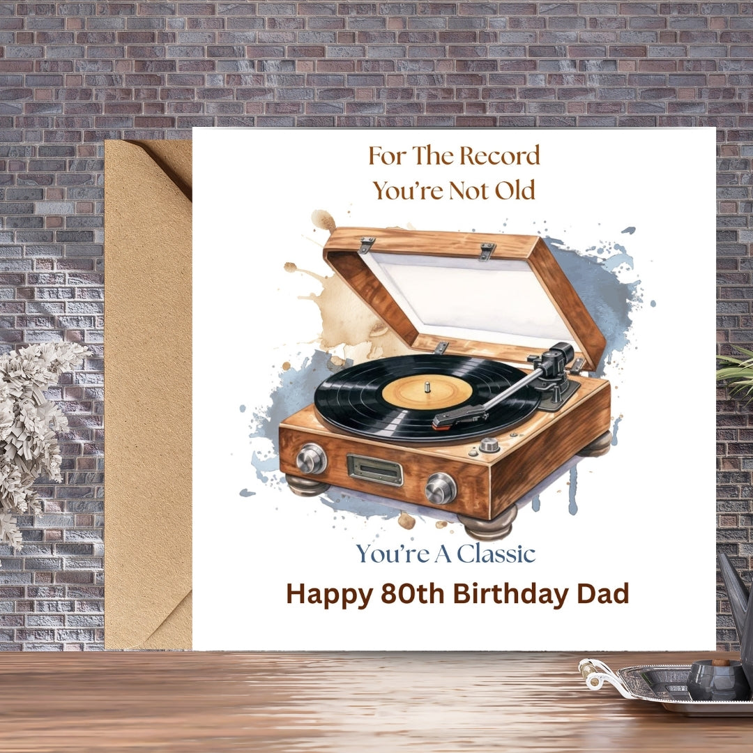 A personalized birthday card for a 80th birthday dad, featuring an illustration of a wooden record player with a vinyl record. The card reads 'For The Record You're Not Old' and 'You're A Classic Happy 80th Birthday Dad'.