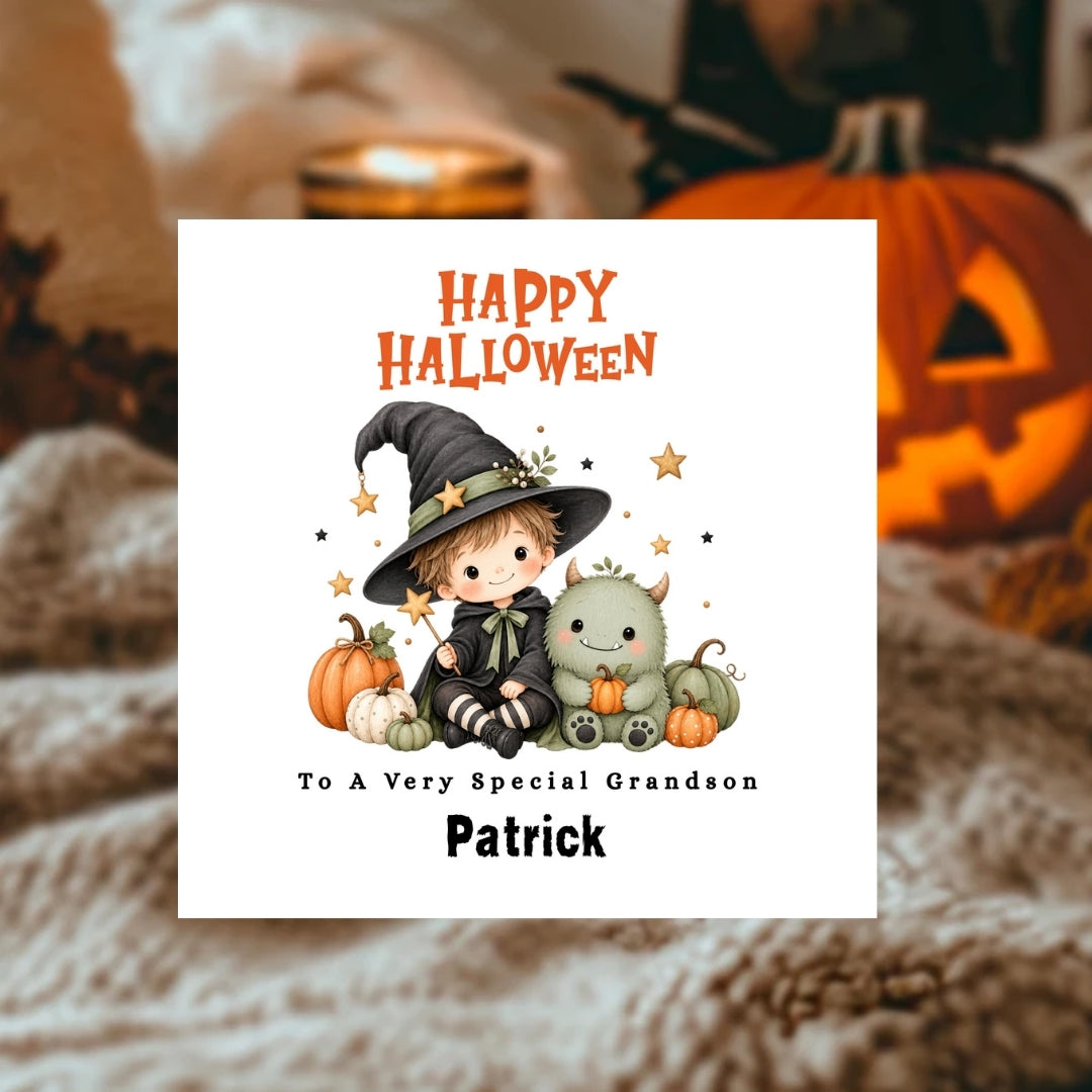 A square white personalized Halloween card with an illustration of a child in a witch hat sitting with pumpkins and a small creature, with the text 'HAPPY HALLOWEEN' and 'To A Very Special Grandson Patrick.' The card is shown against a softly blurred cozy background with a lit candle and a carved pumpkin.